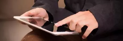 A blurred picture of two hands holding a tablet